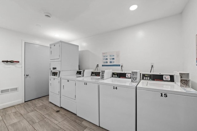 clothes washing area featuring washer and dryer and stacked washer and clothes dryer