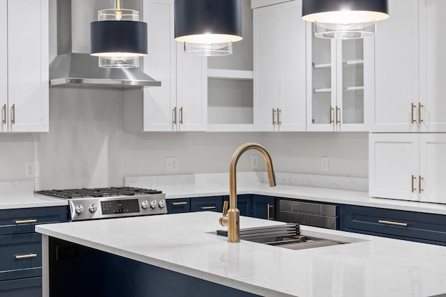 kitchen with white cabinets, sink, blue cabinets, and exhaust hood