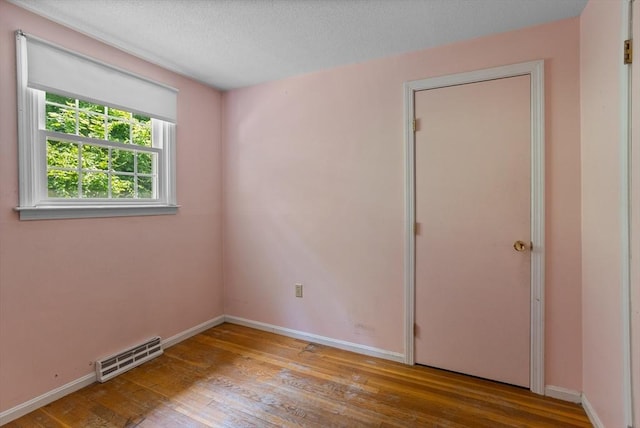 16 Winding Ln, Lowell, MA 01852 - spare room with wood finished floors and baseboards