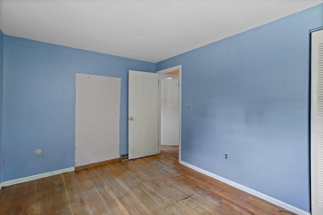 16 Winding Ln, Lowell, MA 01852 - unfurnished bedroom featuring wood finished floors and a closet