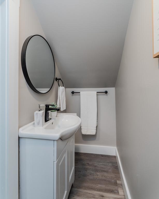 7 2nd Ave, Ware, MA 01082 - bathroom featuring lofted ceiling, vanity, and wood finished floors