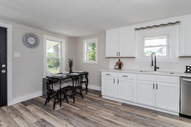 7 2nd Ave, Ware, MA 01082 - kitchen featuring dishwasher, light wood-style flooring, white cabinets, and light countertops
