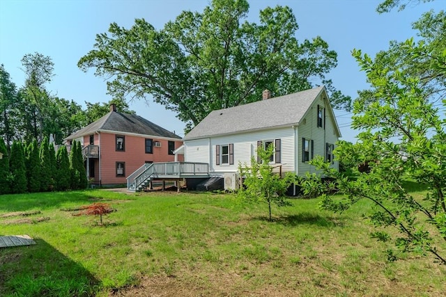 7 2nd Ave, Ware, MA 01082 - back of property with a deck, a yard, and a chimney