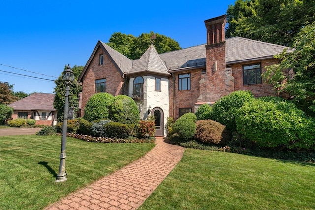 english style home with a front yard