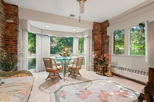 sunroom featuring radiator and a wealth of natural light