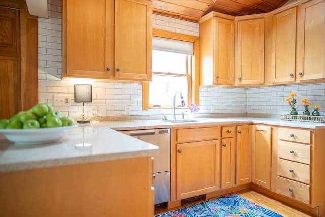 11 Cliff St, Dennis, MA 02638 - kitchen with stainless steel dishwasher, a sink, wooden ceiling, light countertops, and backsplash