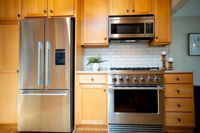 11 Cliff St, Dennis, MA 02638 - kitchen with stainless steel appliances, light countertops, backsplash, and wood finished floors