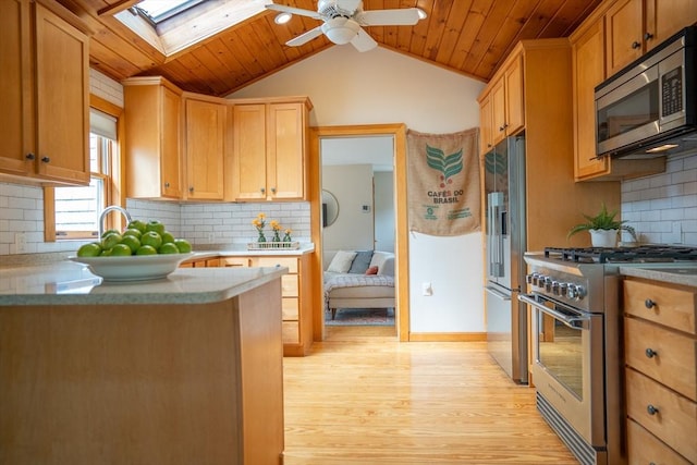 11 Cliff St, Dennis, MA 02638 - kitchen with high quality appliances, ceiling fan, light wood-style floors, vaulted ceiling, and a skylight