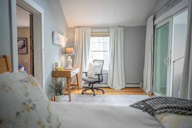 11 Cliff St, Dennis, MA 02638 - bedroom with vaulted ceiling, a baseboard radiator, and wood finished floors