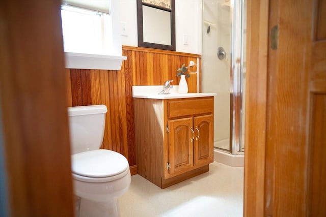 11 Cliff St, Dennis, MA 02638 - bathroom featuring a wainscoted wall, a shower stall, toilet, vanity, and wood walls