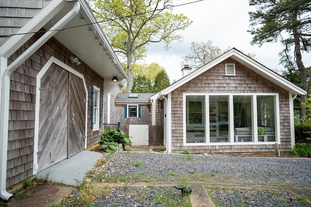 11 Cliff St, Dennis, MA 02638 - rear view of house with a chimney