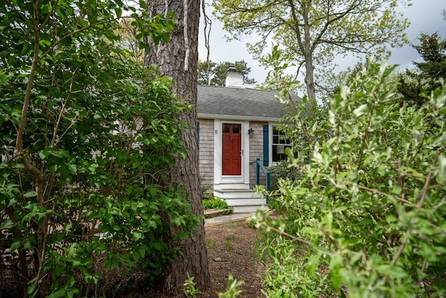 11 Cliff St, Dennis, MA 02638 - view of front facade featuring roof with shingles, a chimney, and entry steps