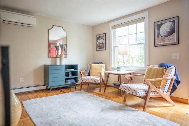 11 Cliff St, Dennis, MA 02638 - living area featuring a wall mounted air conditioner, baseboard heating, and wood finished floors