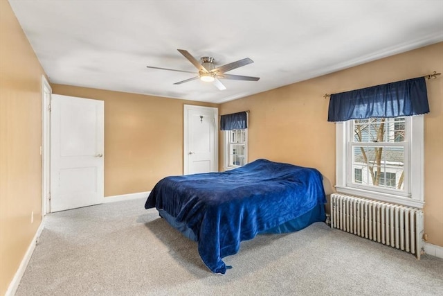 bedroom with ceiling fan, radiator heating unit, and carpet flooring