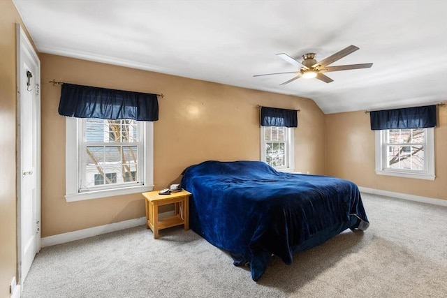 carpeted bedroom with ceiling fan and vaulted ceiling