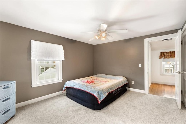 bedroom featuring ceiling fan and light colored carpet