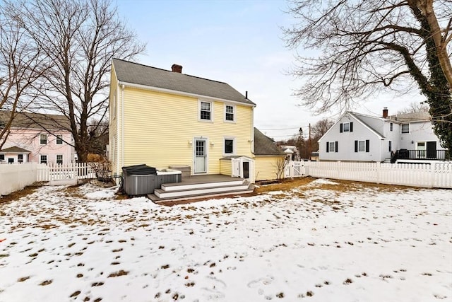 snow covered house featuring a deck