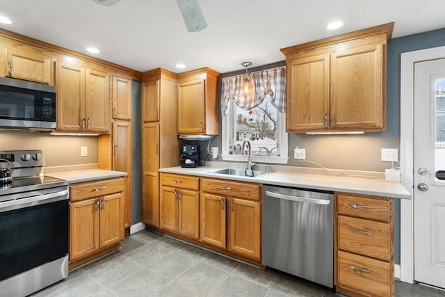 kitchen with sink, pendant lighting, and appliances with stainless steel finishes