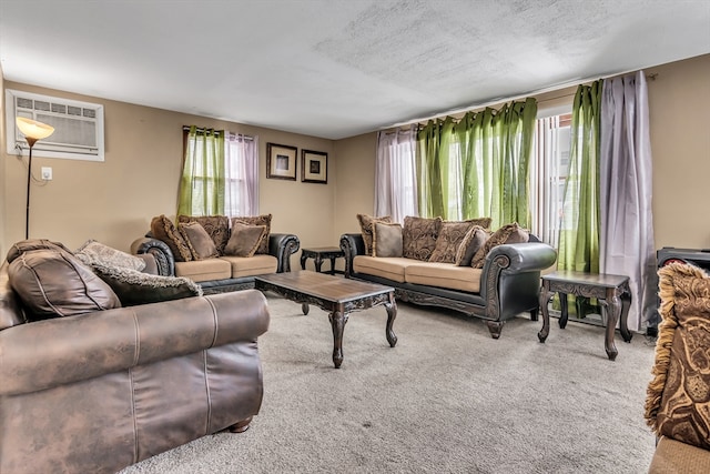 living area featuring a textured ceiling, a wall unit AC, and light colored carpet