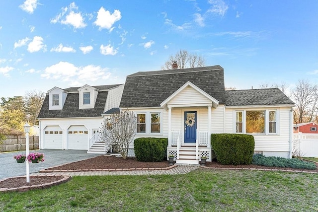 colonial inspired home featuring fence, a shingled roof, a garage, a front yard, and driveway