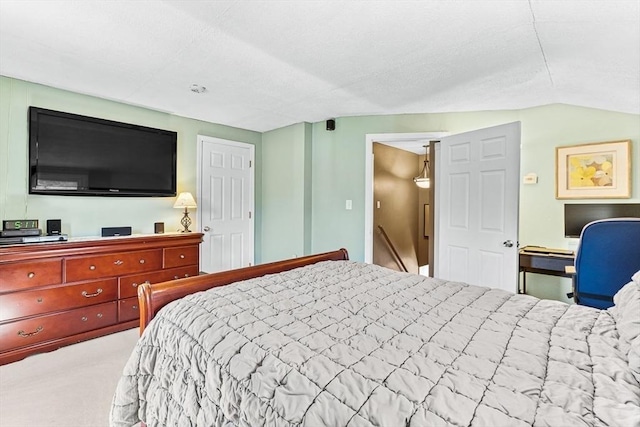 bedroom with carpet and lofted ceiling
