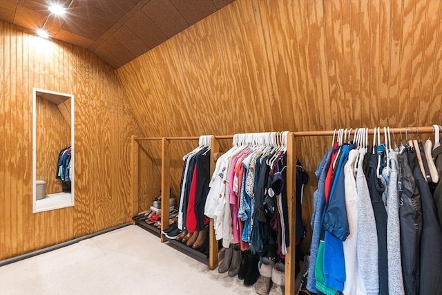 spacious closet with carpet flooring and vaulted ceiling