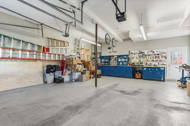 garage featuring a garage door opener and a workshop area