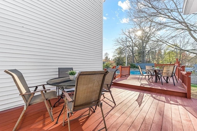 wooden terrace with outdoor dining space
