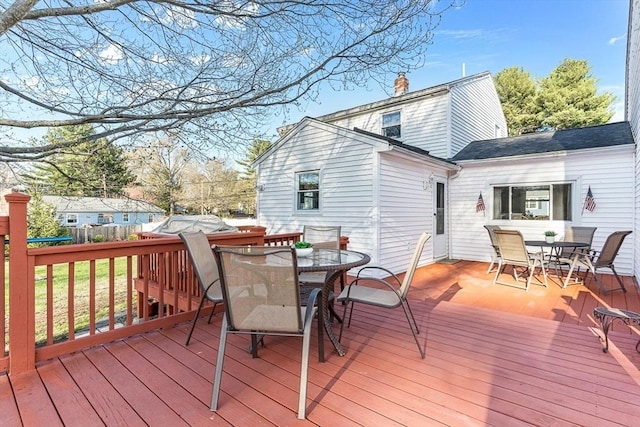 wooden deck with fence and outdoor dining area