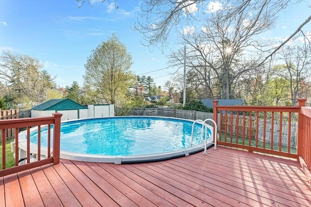view of pool featuring a fenced backyard, a fenced in pool, and a wooden deck