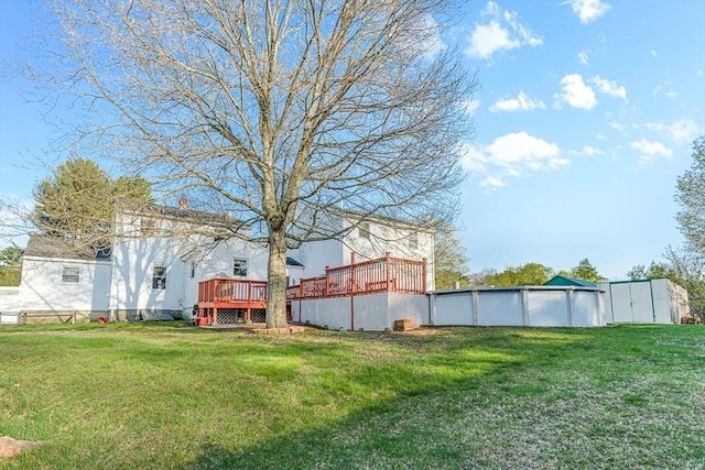 view of yard with a pool and a deck