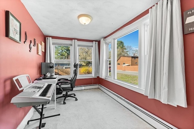carpeted home office featuring baseboards, a baseboard heating unit, and a healthy amount of sunlight