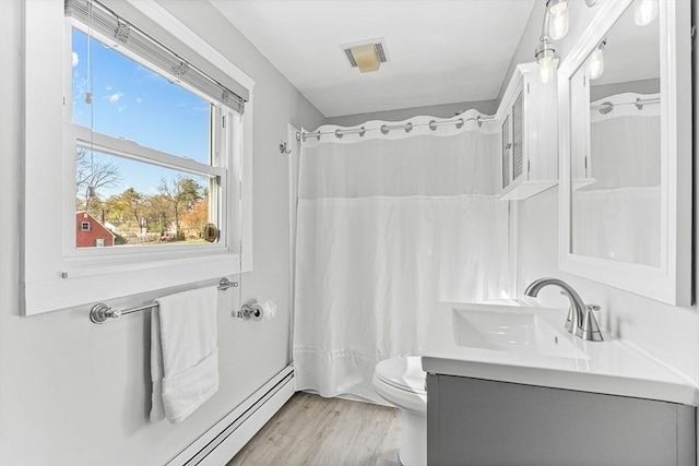 full bathroom featuring a shower with curtain, visible vents, wood finished floors, vanity, and toilet