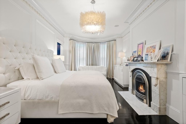68 W Rutland Sq, Boston, MA 02118 - bedroom featuring ornamental molding, a fireplace with flush hearth, dark wood finished floors, and a decorative wall