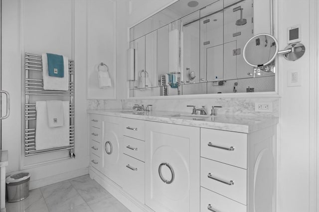 68 W Rutland Sq, Boston, MA 02118 - bathroom with radiator heating unit, marble look tile flooring, a towel warmer, double vanity, and a shower