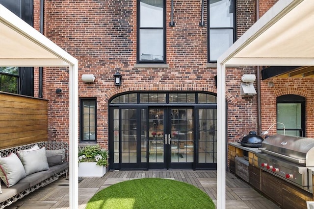 68 W Rutland Sq, Boston, MA 02118 - property entrance featuring brick siding, french doors, and exterior kitchen