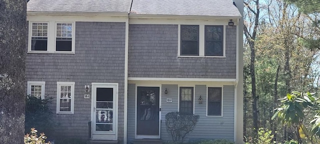 view of property with roof with shingles