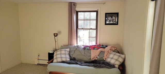 sitting room featuring baseboards, carpet flooring, and a baseboard heating unit