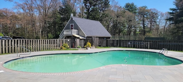 view of swimming pool with a patio area, fence, and a fenced in pool