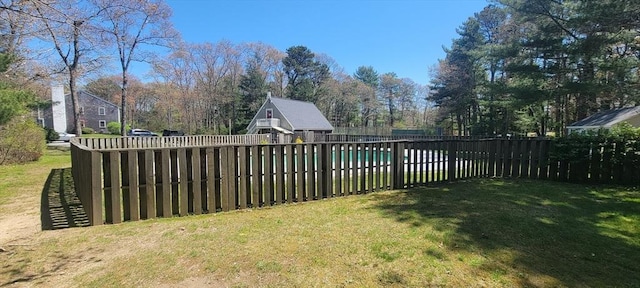 view of yard with a fenced in pool and fence