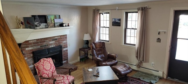 living room with a brick fireplace, wood finished floors, crown molding, and baseboard heating