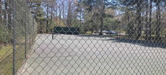 view of tennis court with fence