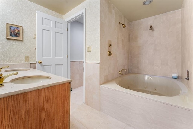 bathroom with tile patterned flooring, vanity, and tiled shower / bath