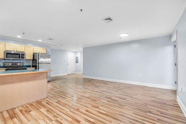 kitchen featuring appliances with stainless steel finishes, backsplash, light brown cabinetry, crown molding, and light hardwood / wood-style floors