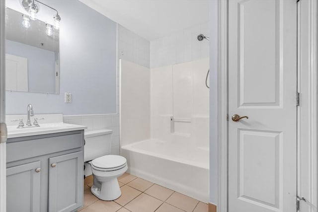 full bathroom featuring vanity,  shower combination, tile patterned flooring, toilet, and tile walls