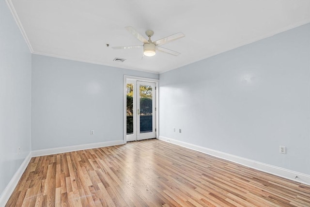 spare room featuring ceiling fan, light hardwood / wood-style floors, crown molding, and french doors