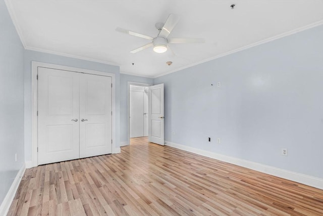 unfurnished bedroom with crown molding, ceiling fan, a closet, and light hardwood / wood-style floors