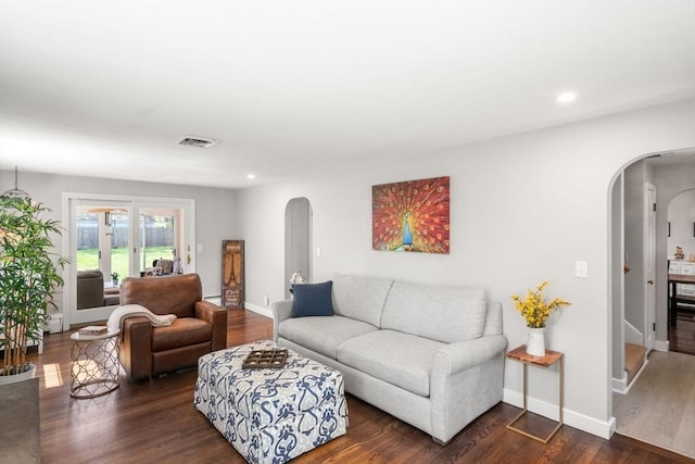 150 Academy St, Braintree, MA 02184 - living area with arched walkways, dark wood-type flooring, recessed lighting, and baseboards