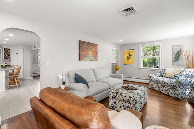 150 Academy St, Braintree, MA 02184 - living room with a baseboard heating unit, arched walkways, wood finished floors, and recessed lighting