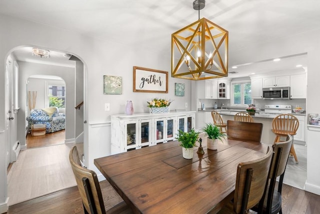 150 Academy St, Braintree, MA 02184 - dining space with arched walkways, wood finished floors, a chandelier, and recessed lighting